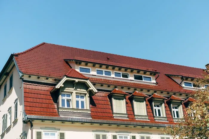 A repaired residential roof under clear sky